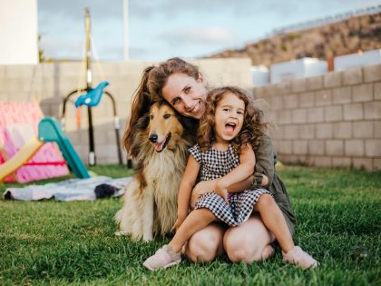 Family helping a newly adopted rescue dog settle in